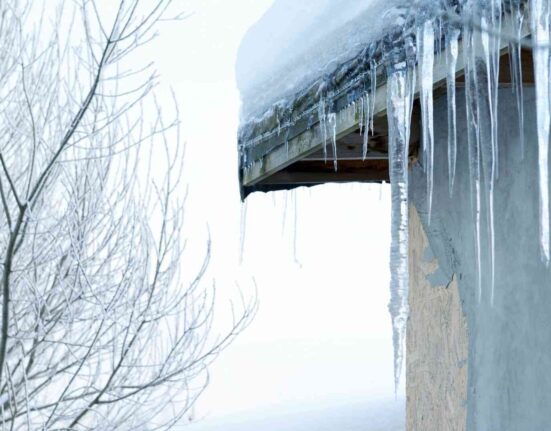 Sople lodu zwisające z krawędzi dachu – zimowe zagrożenie dla przechodniów